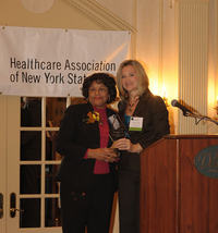Gladiola Sampson (left), President of the Auxiliary of North Shore University Hospital, Manhasset, is presented with the Auxiliary of the Year Award by Sue Ellen Wagner, HANYS Vice President of Community Health and Executive Director, Healthcare Trustees of New York State. Gladiola Sampson (left), President of the Auxiliary of North Shore University Hospital, Manhasset, is presented with the Auxiliary of the Year Award by Sue Ellen Wagner, HANYS Vice President of Community Health and Executive Director, Healthcare Trustees of New York State.